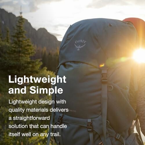 Person with backpack in a scenic mountain setting at sunrise.